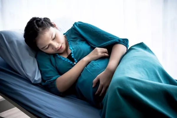Pregnant woman resting on the hospital bed 