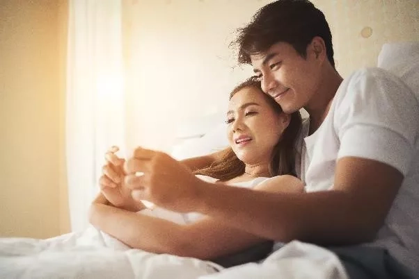 couple looking at the results of their test kit happily