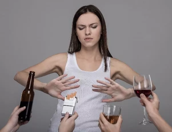 woman rejecting cigarettes and alcoholic drinks