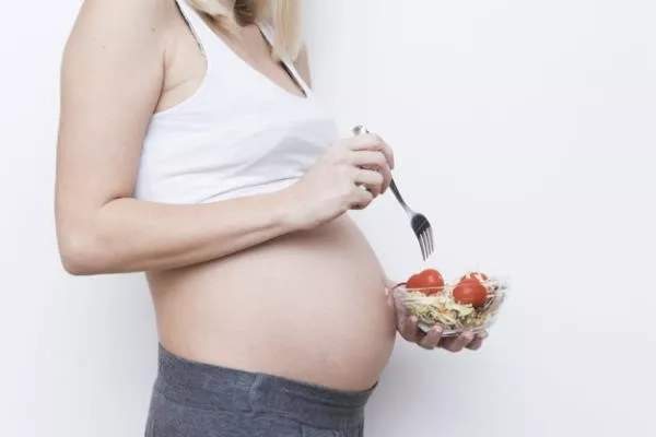 Pregnant woman eating a balanced meal