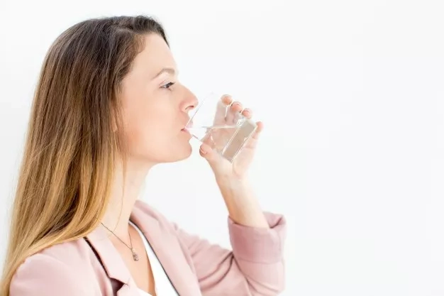 woman drinking from a glass of water