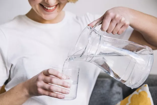 woman-filling-glass-with-water