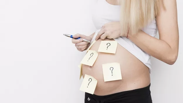 pregnant woman with notes on body