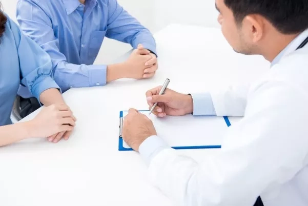 married couple consulting doctor on fertility issues